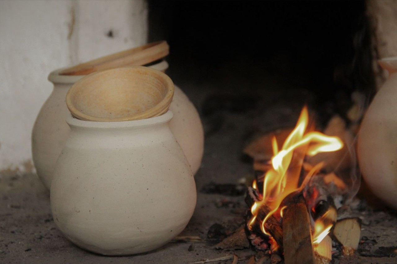 Spherical pots (replicas: late 13th century, Würzburg, Bavaria, Germany) by the fire on the stove. 